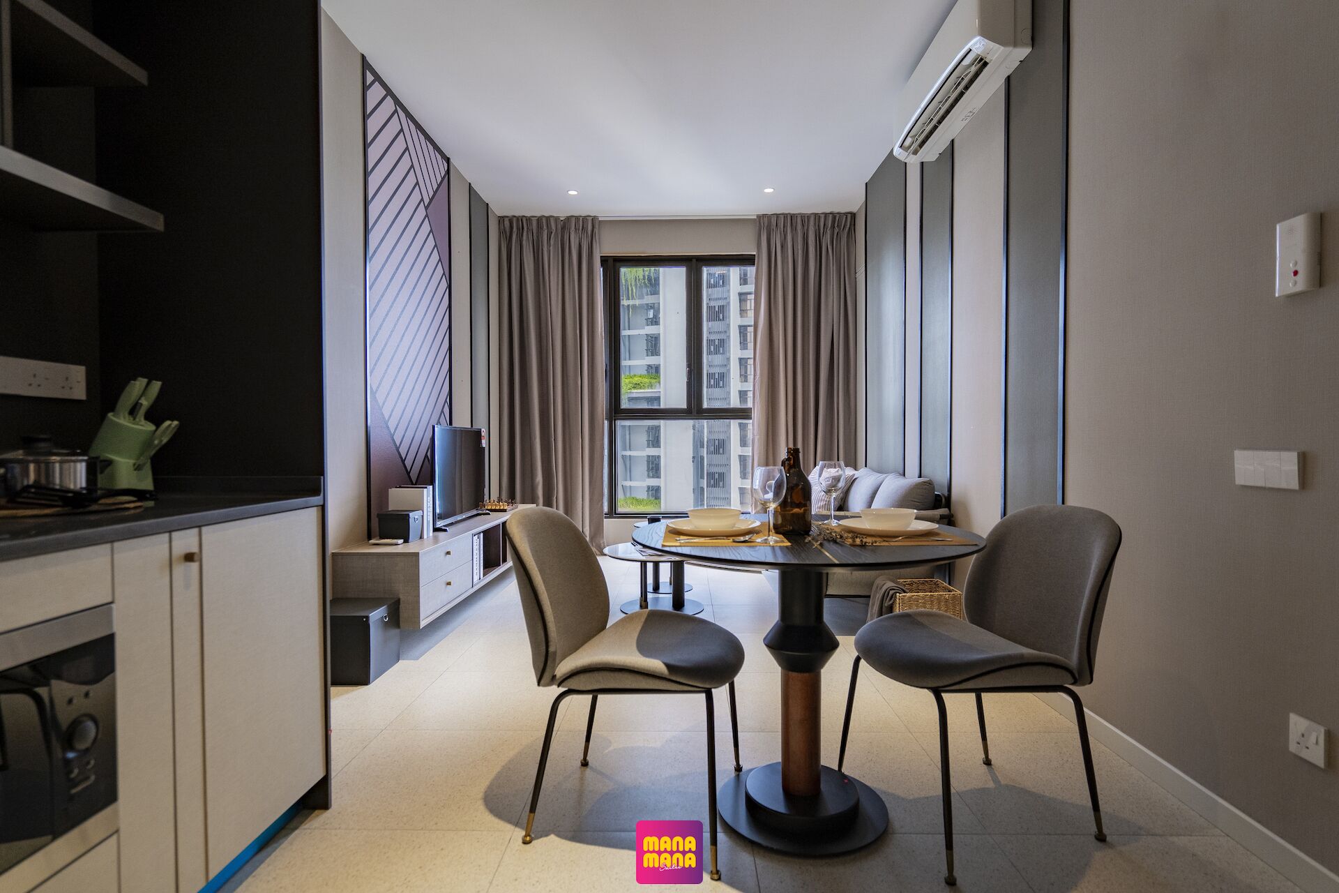 A modern kitchen with a dining area, a television, and a view of the city.
