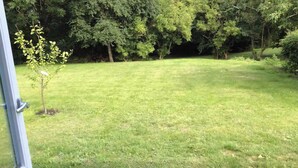 A grassy outdoor area with trees in the background. - Relaxing holiday in quiet surroundings (Frederikshavn)