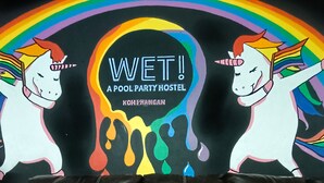 A colorful mural with the text 'WET! A POOL PARTY HOSTEL' and 'KOH PHANGAN' on a black background. - WET a Pool Party Hostel by Wild & Wandering (Ko Pha-ngan)