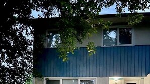 A two-story house with a front porch, a small garden area, and a visible garage door. - Beautiful and Spacious 3 BDR/3 Beds Home (Winnipeg)