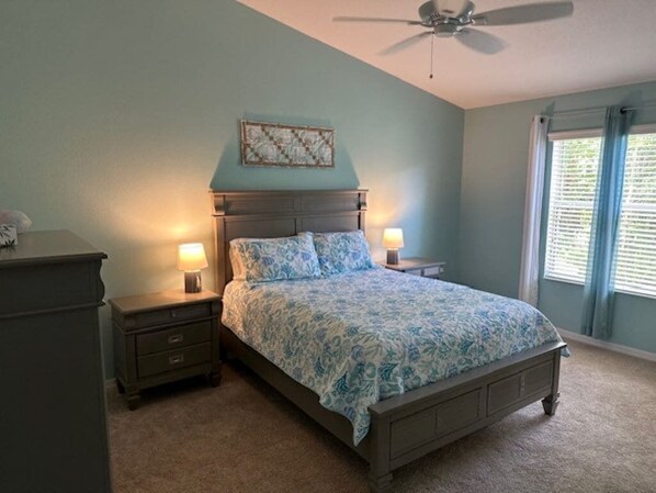 A bedroom with a bed, two bedside tables, a ceiling fan, and a window with blinds. - 2 bedroom / 2 full bath with great location in The Villages! (The Villages)