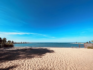 A beach with a clear sky, sandy shore, and a few boats in the water. - 3-Min Walk to Sandy Beach | 3BR Georgian Bay Cottage | Fire Pit + BBQ! (Penetanguishene)