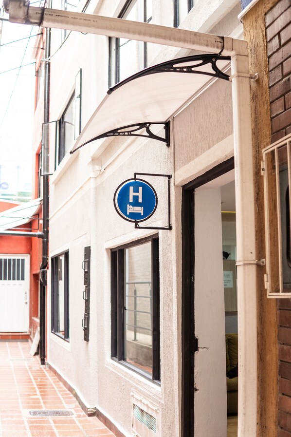 A hotel entrance with a sign indicating it is a hotel.