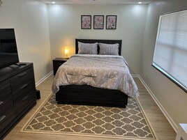 Cubrecamas, escritorio y espacio para trabajar con laptop 