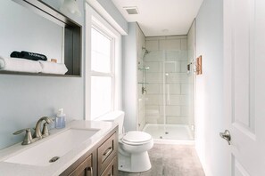 Shower, hair dryer, towels, shampoo