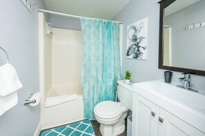 Bathtub, hair dryer, towels, shampoo