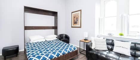 2 habitaciones, escritorio y tabla de planchar con plancha