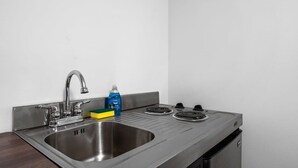 A stainless steel kitchen with a sink, faucet, and stove. - TC Wine Country Stay | Near Beach + Sleeps 4 (Traverse City)