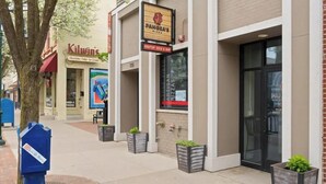 A storefront with a sign for 'Panera's Pizza' and 'Kilwin's' across the street. - Peninsula One Apartments Unit 17 (Traverse City)