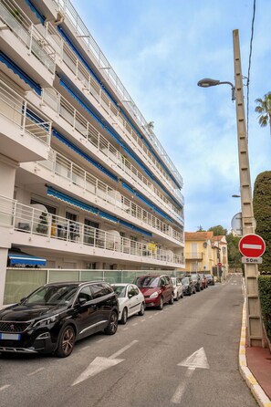 A multi-story building with balconies, parked cars, and a no-entry sign. - Le Royal Studio adorable avec terrasse (Cannes)