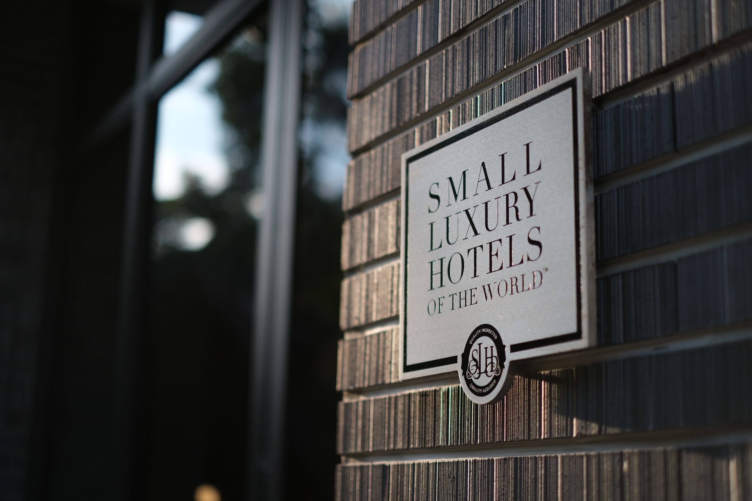 A sign on a building that reads "Small Luxury Hotels of the World".