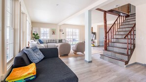 A spacious living area with a staircase, a sofa, and a coffee table.