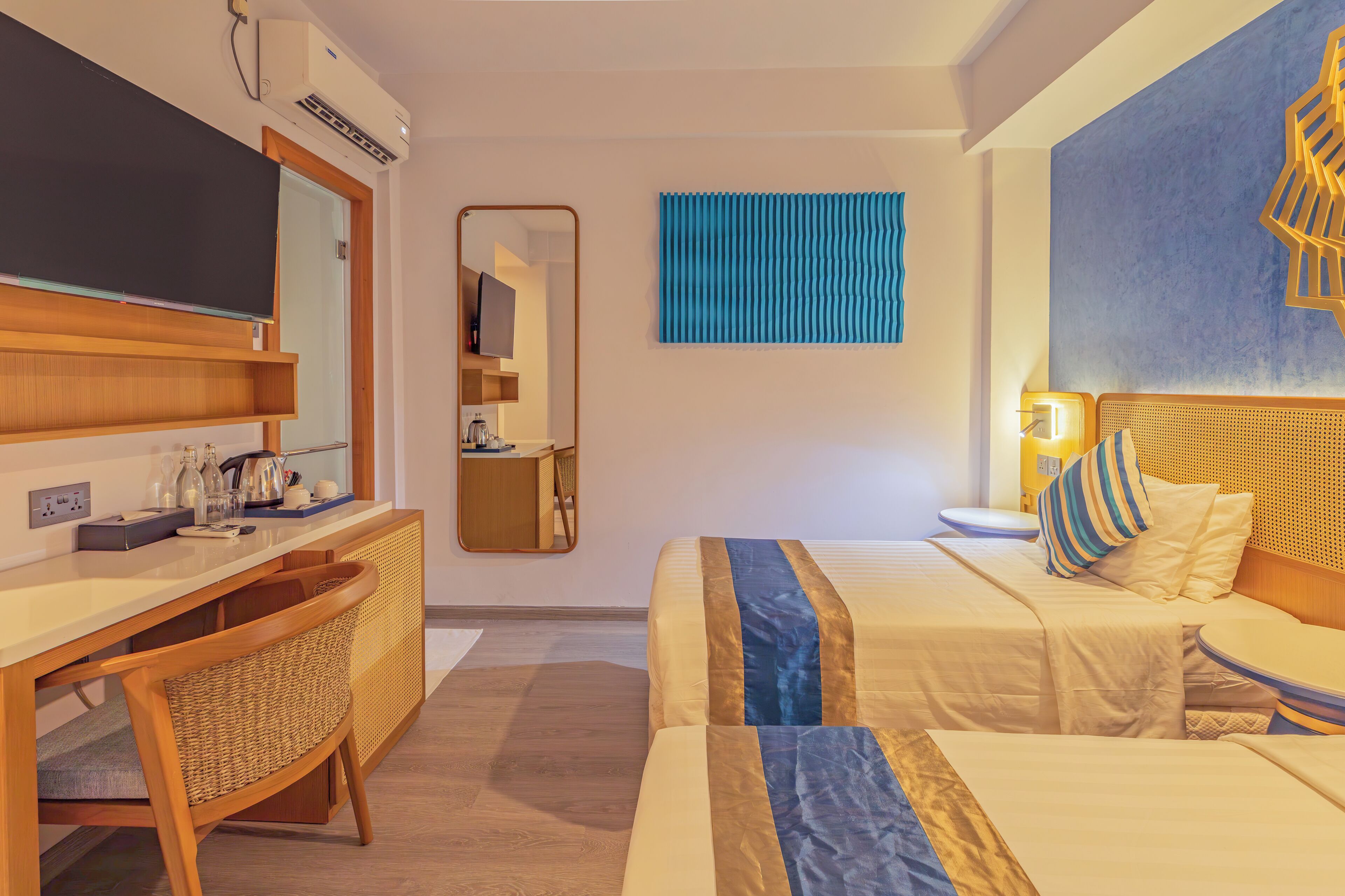 Una habitación de hotel con cama, mesita de noche y escritorio con silla.