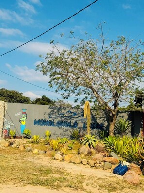 A sign with 'MOHOLOLO LODGE' and a mural of a woman. - Moholoholo lodge  (Bushbuckridge)