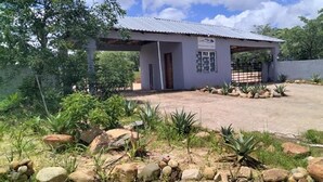 A small, single-story building with a metal roof and a sign above the entrance. - Moholoholo lodge  (Bushbuckridge)