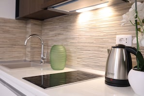 One Bedroom Apartment with Terrace and Partial Sea View (Ground Floor) | Private kitchen | Fridge, stovetop, cookware/dishes/utensils, dining tables - Bellezza Resort & SPA (Morinj)