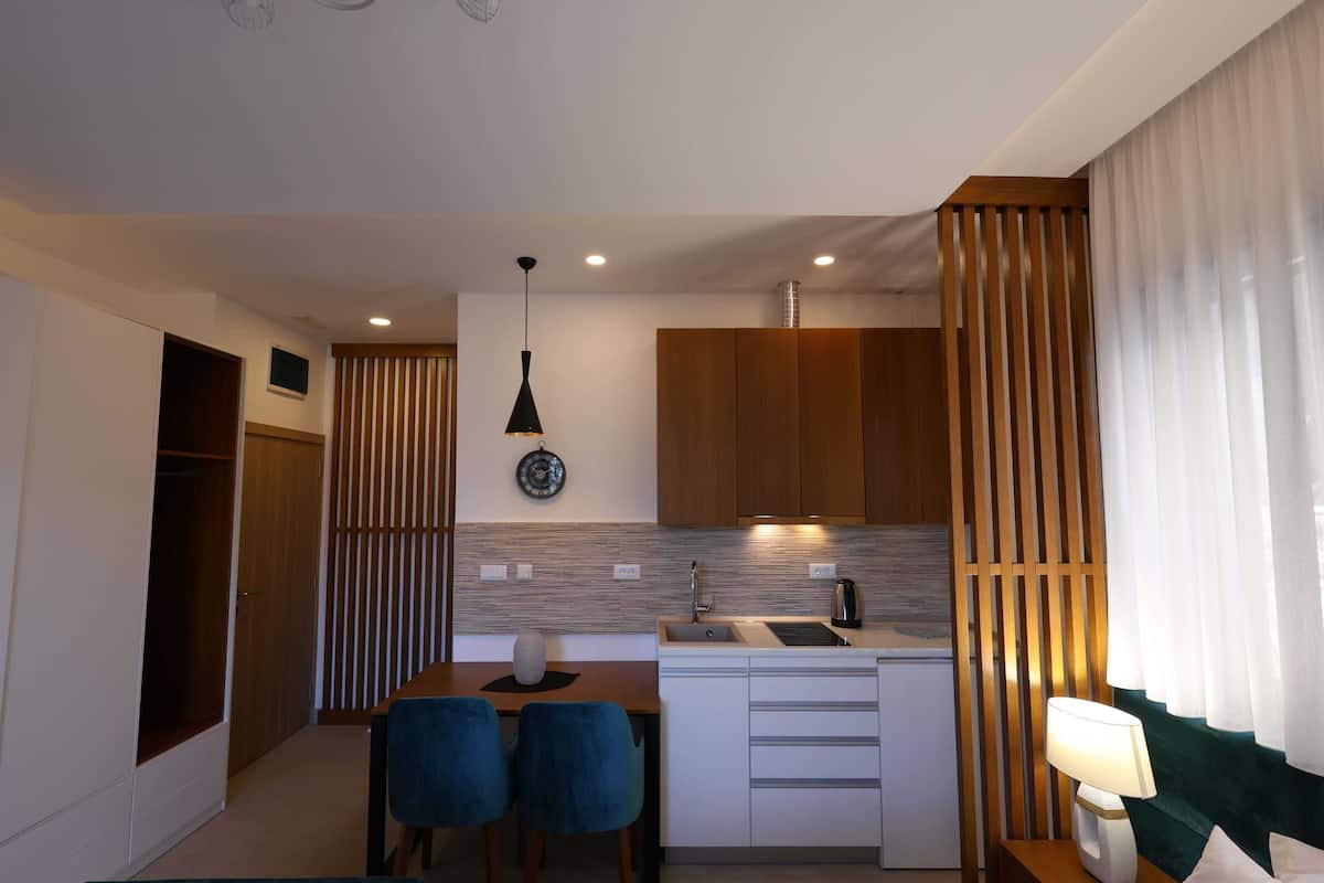Deluxe Studio with Balcony (2 Adults) | Living area | 55-cm LCD TV with cable channels, TV