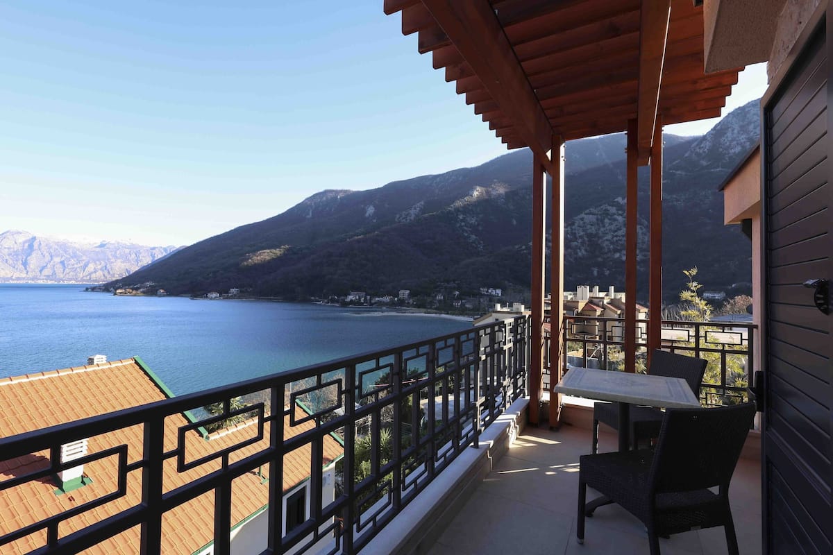 Un balcon avec vue sur un lac et des montagnes.
