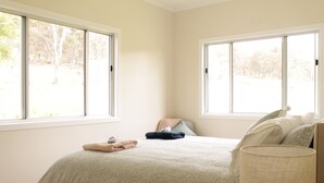 A bedroom with a bed, pillows, a bedside lamp, and two windows. - Lovely farm stay in the northern Granite Belt.  8 minutes from wineries. (Dalveen)