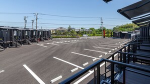 A parking lot with marked lanes and a row of portable restrooms. - HOTEL R9 The Yard Izumi (Izumi)