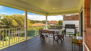 Enjoy al fresco dining on the elevated deck with a barbecue grill and scenic views of the surrounding landscape.