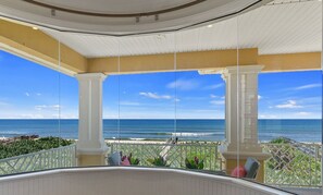 A balcony with a view of the ocean, white columns, and a railing. - Oceanfront Family Retreat | Pool & Spa | Elevator | Views (Palm Coast)