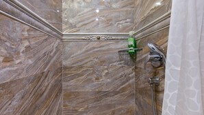 A bathroom with marble walls, a shower, and a green bottle on the wall. - Luxury Authentic Studio Split Old-Town (Split)