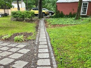 Drive up to a charming home with a driveway and beautifully landscaped surroundings.