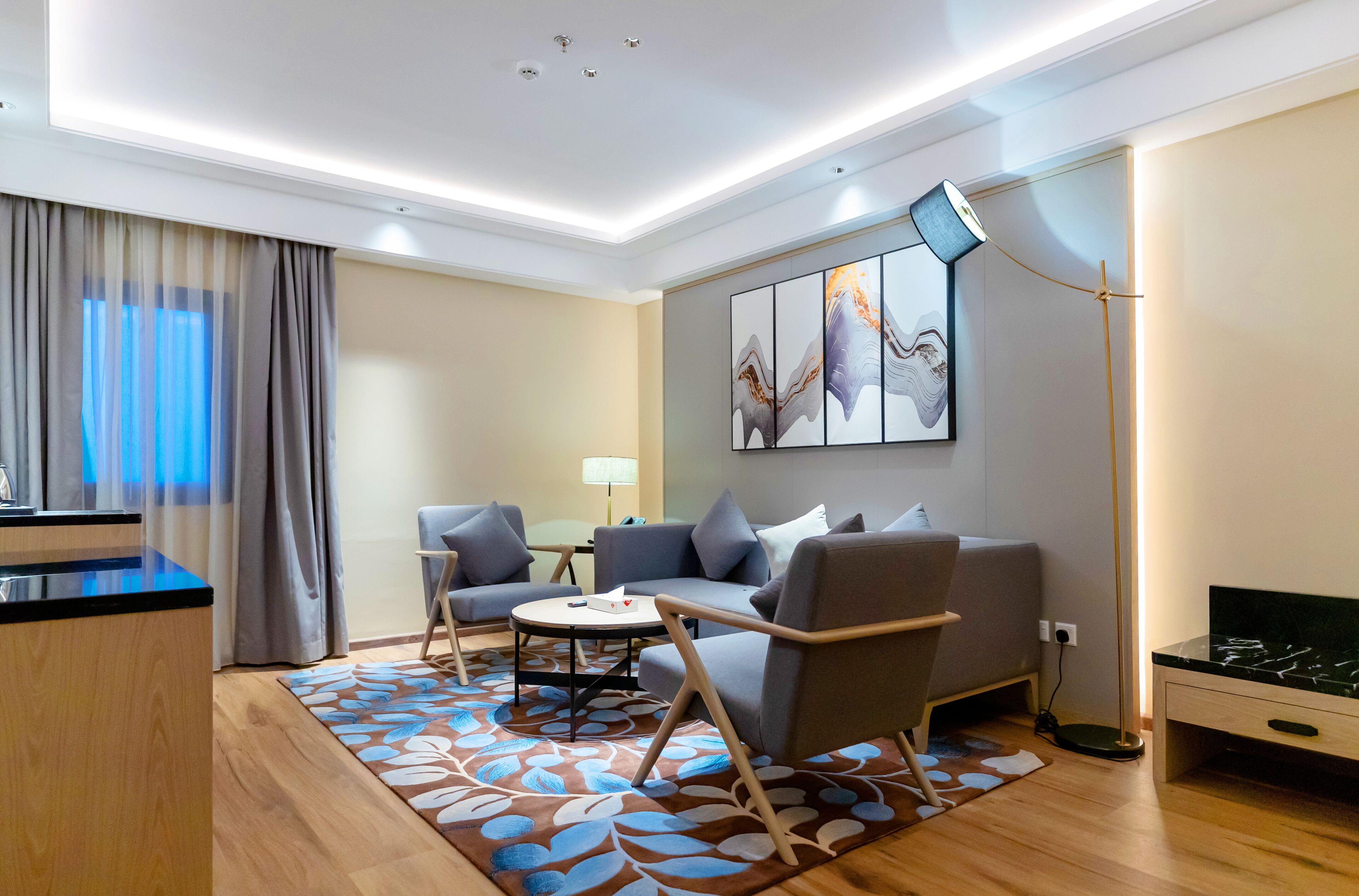 A modern living room with a sofa, a coffee table, and a TV stand.