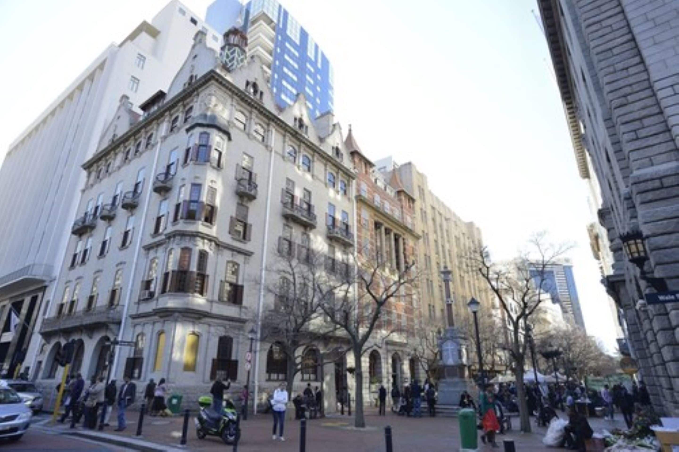 A historic building with multiple floors, large windows, and a prominent entrance.