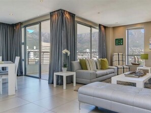 Two Bedroom Platinum Apartment | Living area | 74-inch flat-screen TV with satellite channels, TV, Netflix