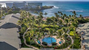 A resort with a large pool surrounded by palm trees, a beach, and ocean views. - Presidential Suites • Turtle Bay 4BR Oceanfront Villa (Kahuku)