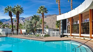 A swimming pool with lounge chairs, palm trees, and a mountain backdrop. - 1957 Modern Hideaway - A Ryson Property (Palm Springs)
