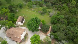 An aerial view of a residential area with several houses surrounded by dense greenery. - A-Frame Cabin on Table Rock Lake, by SDC! (Branson)