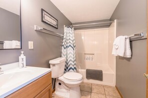 A bathroom with a toilet, sink, shower, and bathtub. - Lakefront cabin- boat slip access, by SDC! (Branson)