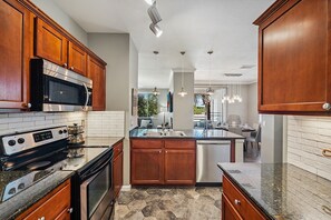 Fridge, microwave, oven, stovetop - At The Plaza - Modern Resort-Style Condo (Scottsdale)