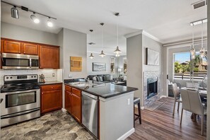 Fridge, microwave, oven, stovetop - At The Plaza - Modern Resort-Style Condo (Scottsdale)