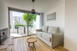 Standard Apartment, 1 Bedroom | Living area | 70-inch flat-screen TV with cable channels, TV