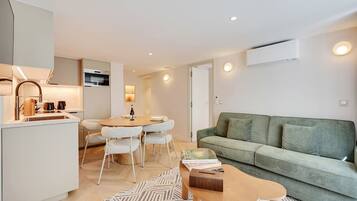 A modern apartment with a kitchen, dining area, and living room.