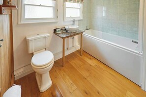 Bathtub, hair dryer, towels, shampoo