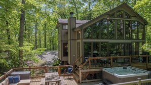 A wooden deck with outdoor seating and a hot tub. - Alpine Woods by Innsbrook Vacations! (Innsbrook)