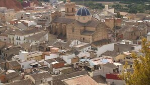 A densely packed urban area with historic buildings, including a prominent structure with a dome.