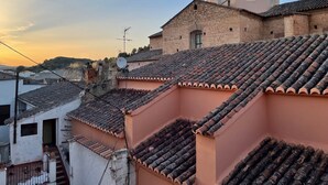 A traditional building with a dome and terracotta tiled roofs.