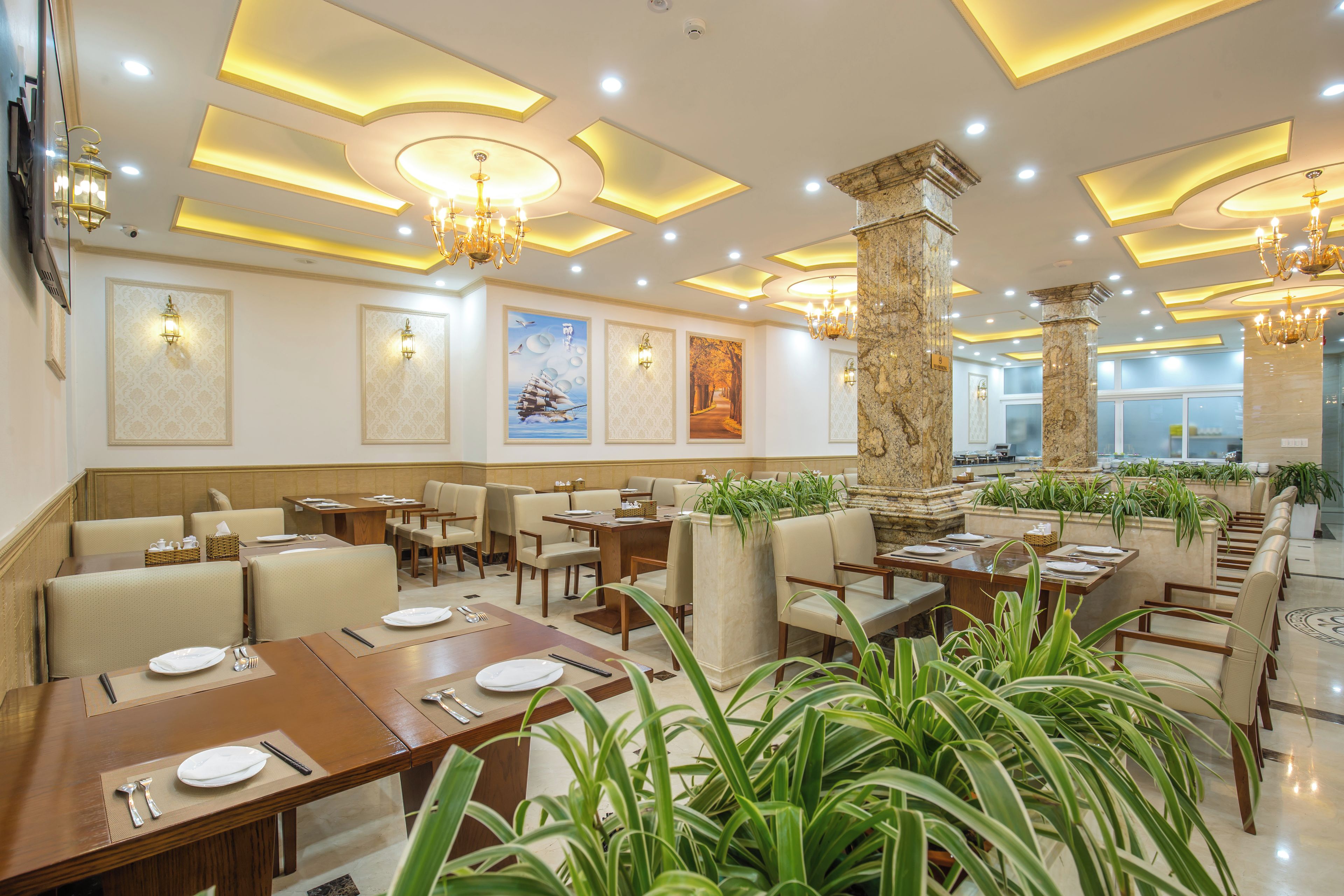 A restaurant with multiple dining tables, chairs, and a variety of wall art.