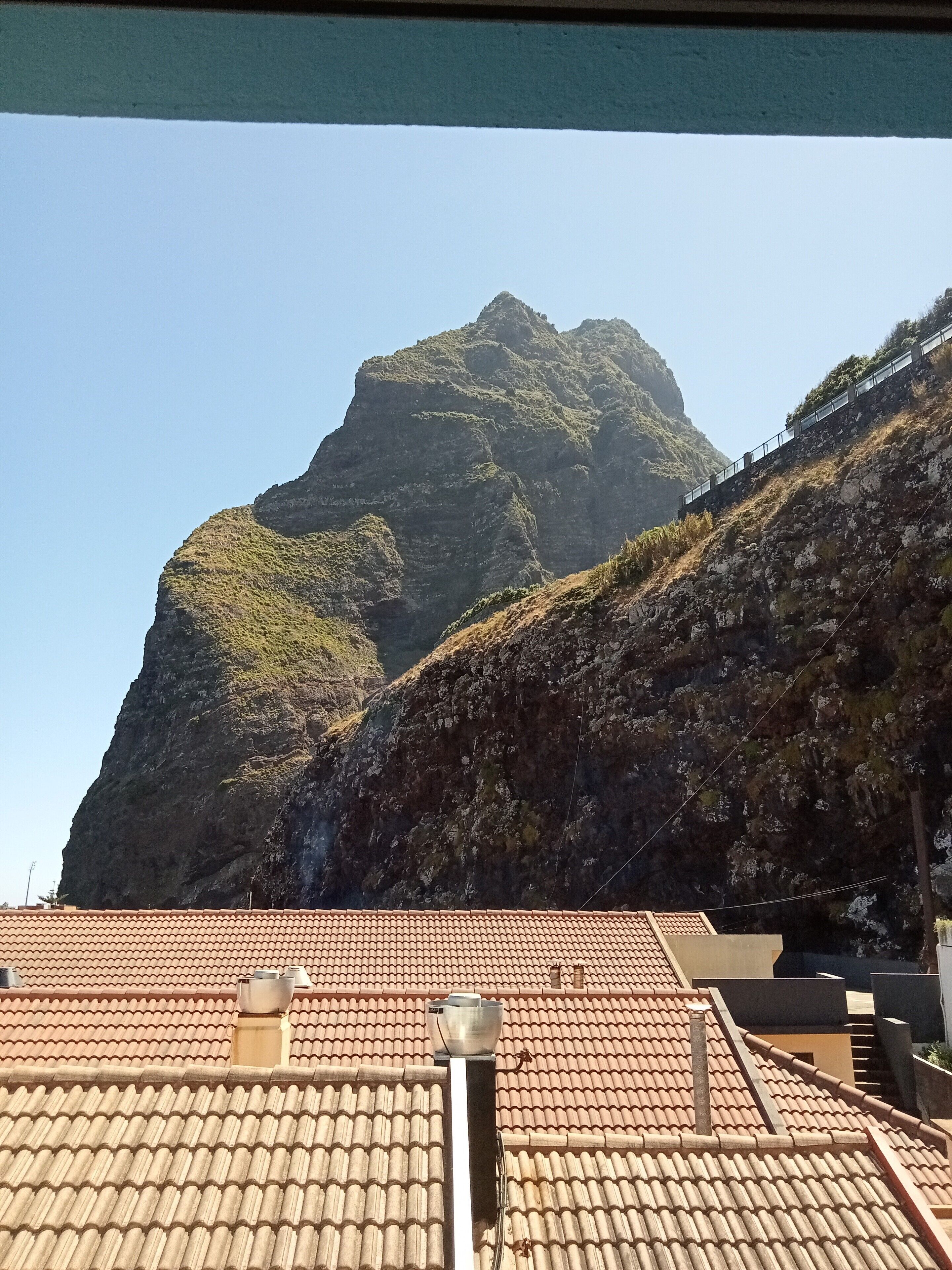 A mountain with a train track ascending its slope.