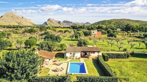 A villa with a swimming pool, surrounded by lush greenery and mountains. - Casita Fontxica - Two Bedroom Villa, Sleeps 4 (Mallorca)