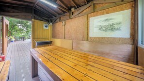 A wooden deck with a bench and a wall-mounted painting. - Ganghwado Elinhuvert Pension (Incheon)
