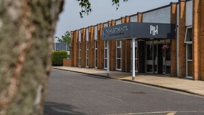 A modern hotel with a prominent sign, a brick facade, and a clear entrance. - The Milestone Hotel, Peterborough (Cambridgeshire), Sure Collection by Best Western (Peterborough)