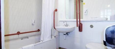 A bathroom with a bathtub, a sink, and a toilet.