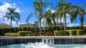 A hot tub with a 3 ft. depth indicator, surrounded by palm trees and a hedge. - Magical 6BR PetFriendly @Encore Near Disney 7722 (Kissimmee)